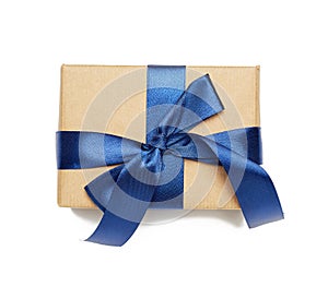 Rectangular box wrapped in brown paper and tied with silk ribbon with a bow
