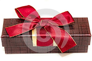 Rectangular brown gift box with bow on white background.