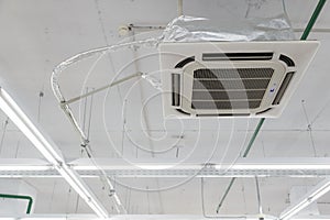 Rectangular ceiling air conditioning appliance. Fan Coil hanging on ceiling. industrial climate gear