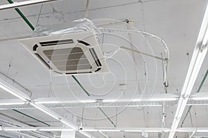 Rectangular ceiling air conditioning appliance. Fan Coil hanging on ceiling. industrial climate gear