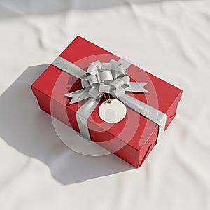 Rectangular gift box adorned with a silver ribbon and bow placed