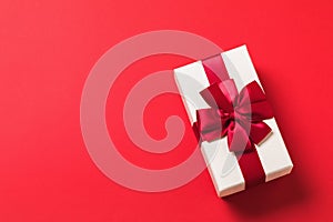 Rectangular gift box on red background with copy of space