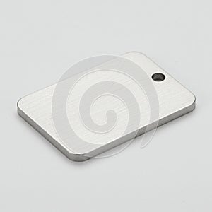 Rectangular metal dog tag with a brushed silver finish, featuring rounded edges. A sm