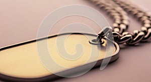 Rectangular metal dog tag with rounded edges attached to a thick, interlocking metal chain. The