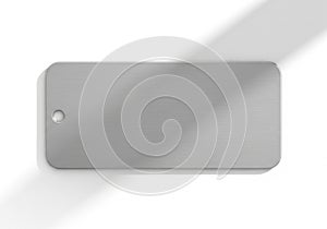 Rectangular metallic tag with rounded corners, featuring a brushed texture. A circular