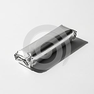 Silver Wrapped Rectangular Object on White Background with Shadow foil wrapper