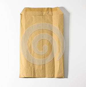 Rectangular open brown kraft paper envelope on white background