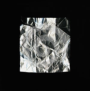 A rectangular piece of crumpled foil. isolated on a black background.