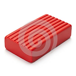 Rectangular Red Modeling Clay Block with Grooved Surface on White Background play-doh
