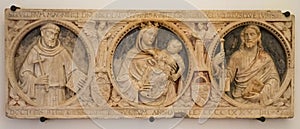 rectangular stone frame depicting saints in the monumental complex of San Lorenzo Maggiore Napoles buried, Italy. photo