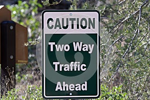 Rectangular traffic sign stating Two Way Traffic Ahead