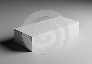 Rectangular white box placed on a smooth, light gray surface. The box