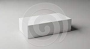 Rectangular white box on a plain, neutral-gray surface. The box has smooth edges