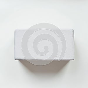 Rectangular white box with a subtle textured surface, placed against a plain white