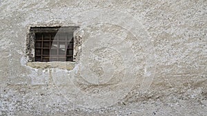 Medieval wall with window and rusted railing photo