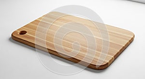 A rectangular wooden cutting board with smooth, rounded edges rests on a white surface. Made from