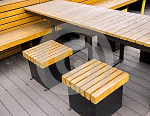 Rectangular wooden table and square ottoman seats