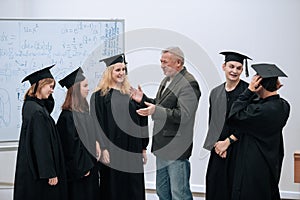 The rector of the university, a professor of mathematics, personally congratulates each of the graduates of the students