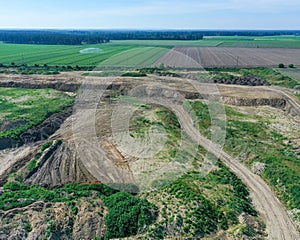 Recultivation area of a gravel pit, with agricultural land in the background, aerial view, destruction