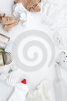 Recyclable waste, resources. Clean glass, paper, plastic and metal on white background. Copyspace for text. Recycling