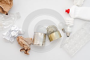 Recyclable waste, resources. Clean glass, paper, plastic and metal on white background. Copyspace for text. Recycling