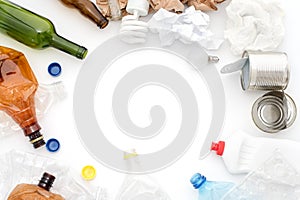 Recyclable waste, resources. Clean glass, paper, plastic and metal on white background. Copyspace for text. Recycling, reuse, garb