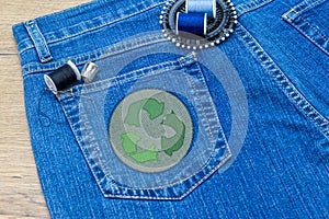 Recycle clothes icon patch on jeans, sustainable fashion visible mending concept