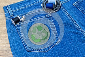 Recycle clothes icon patch on jeans, sustainable fashion visible mending concept photo
