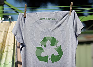 Recycle clothes icon on t shirt with 100% Recycled text, concept illustration reuse, recycle clothes and textiles to reduce waste
