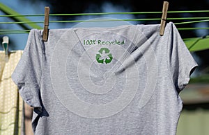 Recycle clothes icon on t shirt with 100% Recycled text, concept illustration reuse, recycle clothes and textiles to reduce waste