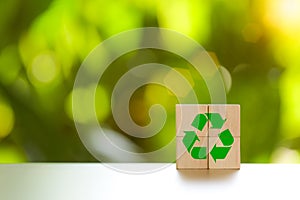 Recycle concept. Green recycle symbol label on wooden block. ecological to save the earth and sustainable development. Responsible