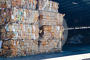 The recycle industry cardboard garbage and paper waste after pressing in hydraulic baling garbage press machine to a square dense