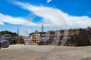 The recycle industry cardboard garbage and paper waste after pressing in hydraulic baling garbage press machine to a square dense