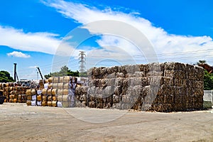 The recycle industry cardboard garbage and paper waste after pressing in hydraulic baling garbage press machine to a square dense