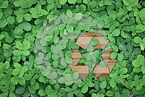 Recycle logo on green leaves background