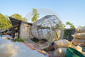 Recycle machine with stack of different types of large garbage dump, plastic bags, and trash bins in urban area in Environmental