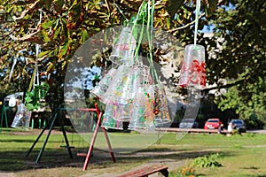 Recycle project of plastic bottles and cups, colored with different colors. Second life for plastic. Kids project in the