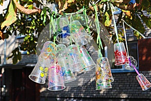 Recycle project of plastic bottles and cups, colored with different colors. Second life for plastic. Kids project in the