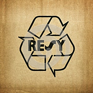 Recycle symbol on cardboard texture