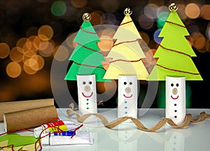 Recycle toilet roll tubes, decorated and reused into Christmas tree decoration with smiling face, homemade quirky fun