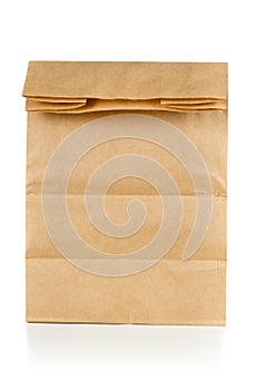 Recycled brown paper doggy bag over white background