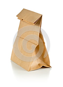 Recycled brown paper doggy bag over white background