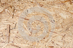 Recycled compressed wood chippings board. The texture of the plywood panel