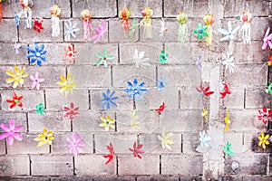 Recycled by cut  empty colorful old plastic bottle in flower shaped for decorative hanging on cement block wall background