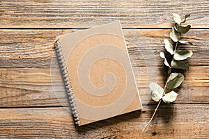 Recycled notepad on wooden background, flat lay, copy space.