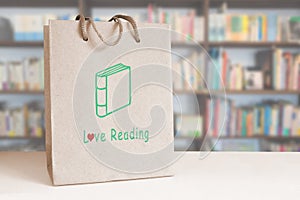 Recycled paper bag on a counter in a bookstore. Empty copy space. Love reading concept.