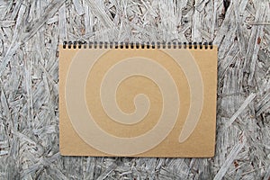 Recycled paper notebook on wood