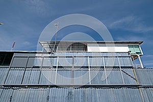 Recycled shipping containers stacked under blue sky