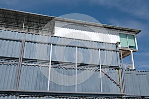 Recycled shipping containers stacked under blue sky