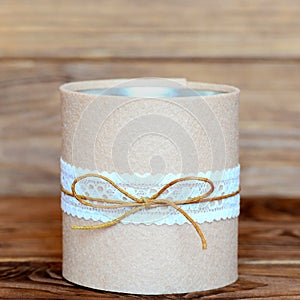 Recycled tin can on wooden background. Decorative tin can crafts. Easy and cheap way to make crafts for home